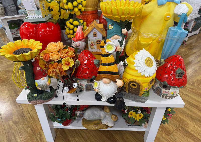 Garden gnomes and colorful decorations on display.